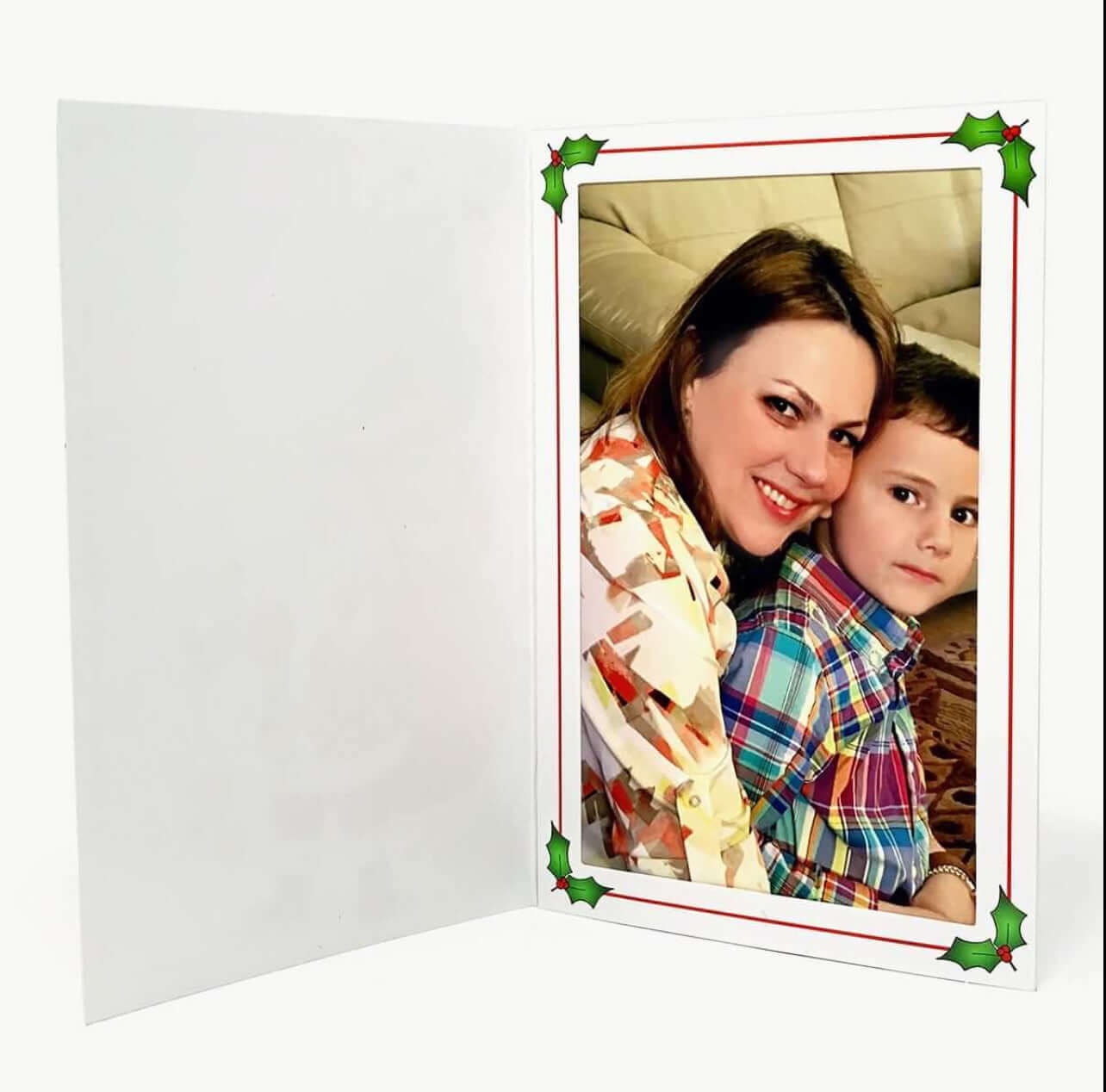 Mother and son posing for a photo inside a festive Christmas photo folder with holly decoration.