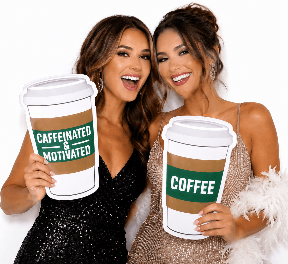Two women happily posing with Coffee Cup PVC Photo Booth Prop 12 Inch Double Sided at an event.