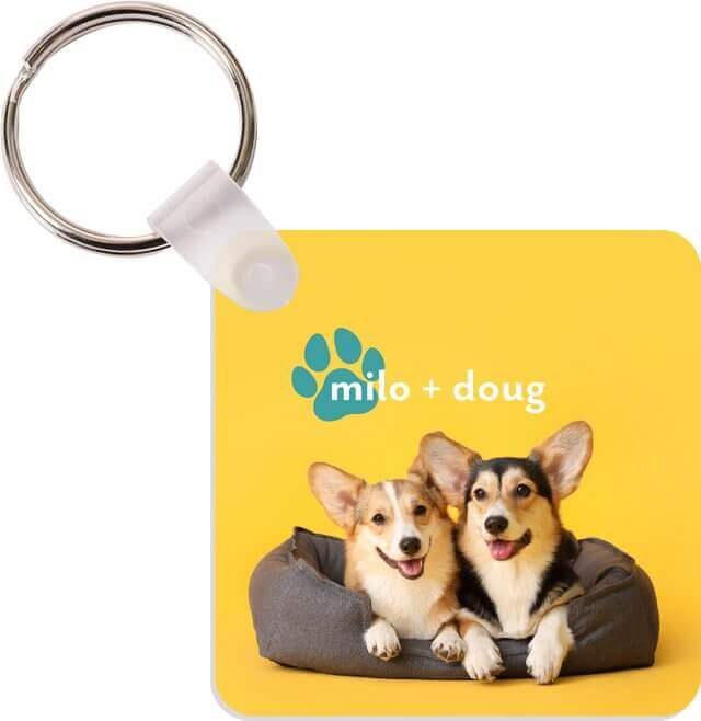 White gloss square keychain featuring two corgi dogs on a yellow background, perfect for pet lovers.