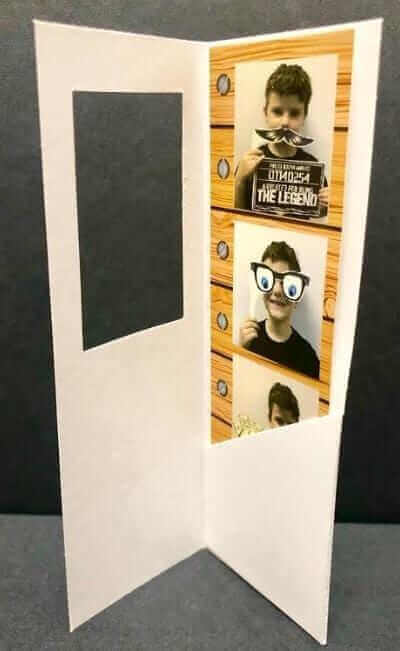 2" x 6" photo booth strip folder in white with window, displaying fun photo strips inside.