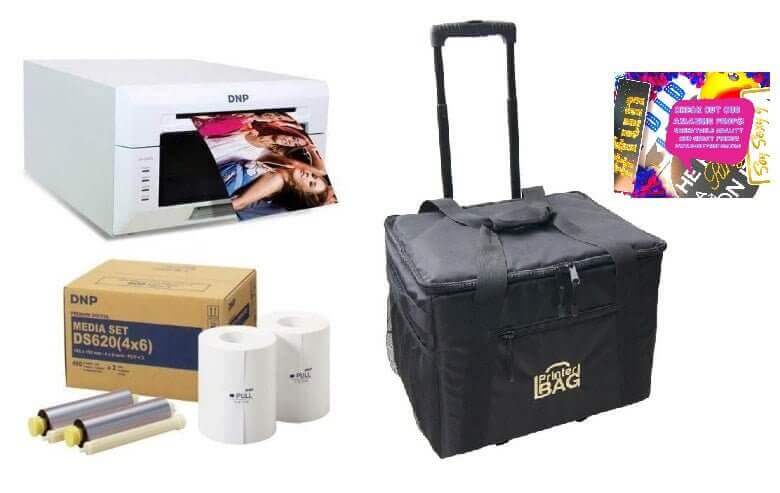 DNP DS620A Dye-Sublimation Printer Bundle with media, rolling case, and photo props for high-quality printing.