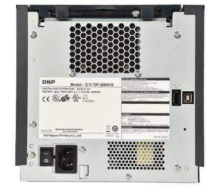 DNP QW410 Photo Printer back view with model and connection ports, showcasing its compact design and features.