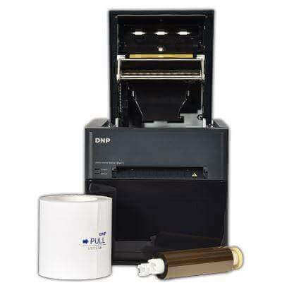 DNP QW410 photo printer with paper and ribbon, showcasing its compact design and portable features.