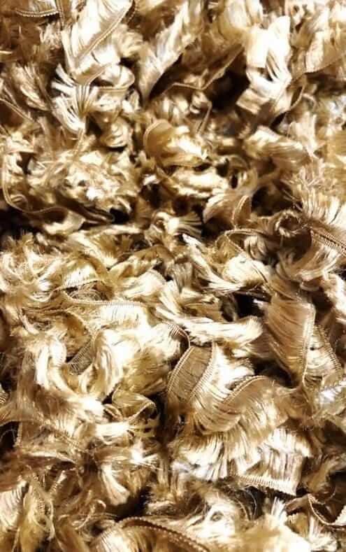 Close-up of soft, golden boa material, showcasing a feather-like texture without actual feathers.