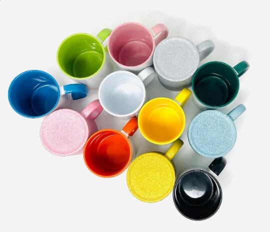 A colorful assortment of 12 fun sublimation mugs in various vibrant colors, showcasing glossy finishes for artwork.