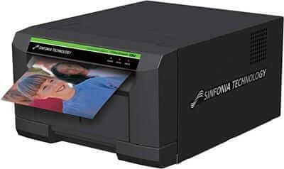 Sinfonia CS2 printer printing a glossy photo, ideal for event photography and photo booths, compact design.