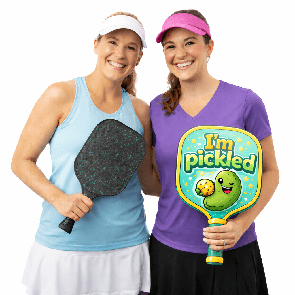 Two women holding pickleball paddles and a colorful Pickleball Time! sign for photo booth props.